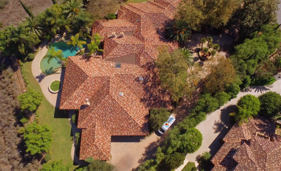 Aerial view of a home in Poway with a West Coast Restoration & Cleaning van