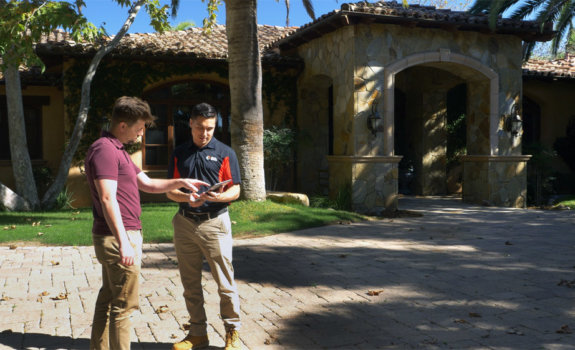 A West Coast Cleaning & Restoration technician advising a client in Poway on the best restoration solution for their home